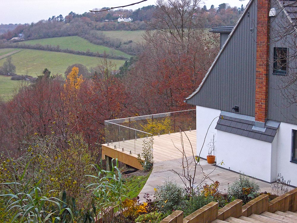 side of house with new across new decking to landscape beyond