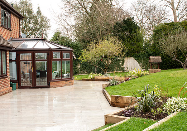 Looking along the rear towards the conservatory showing new sleeper edging and new planting